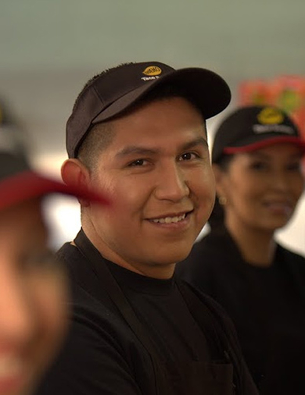 A smiling Taco Bueno team member.