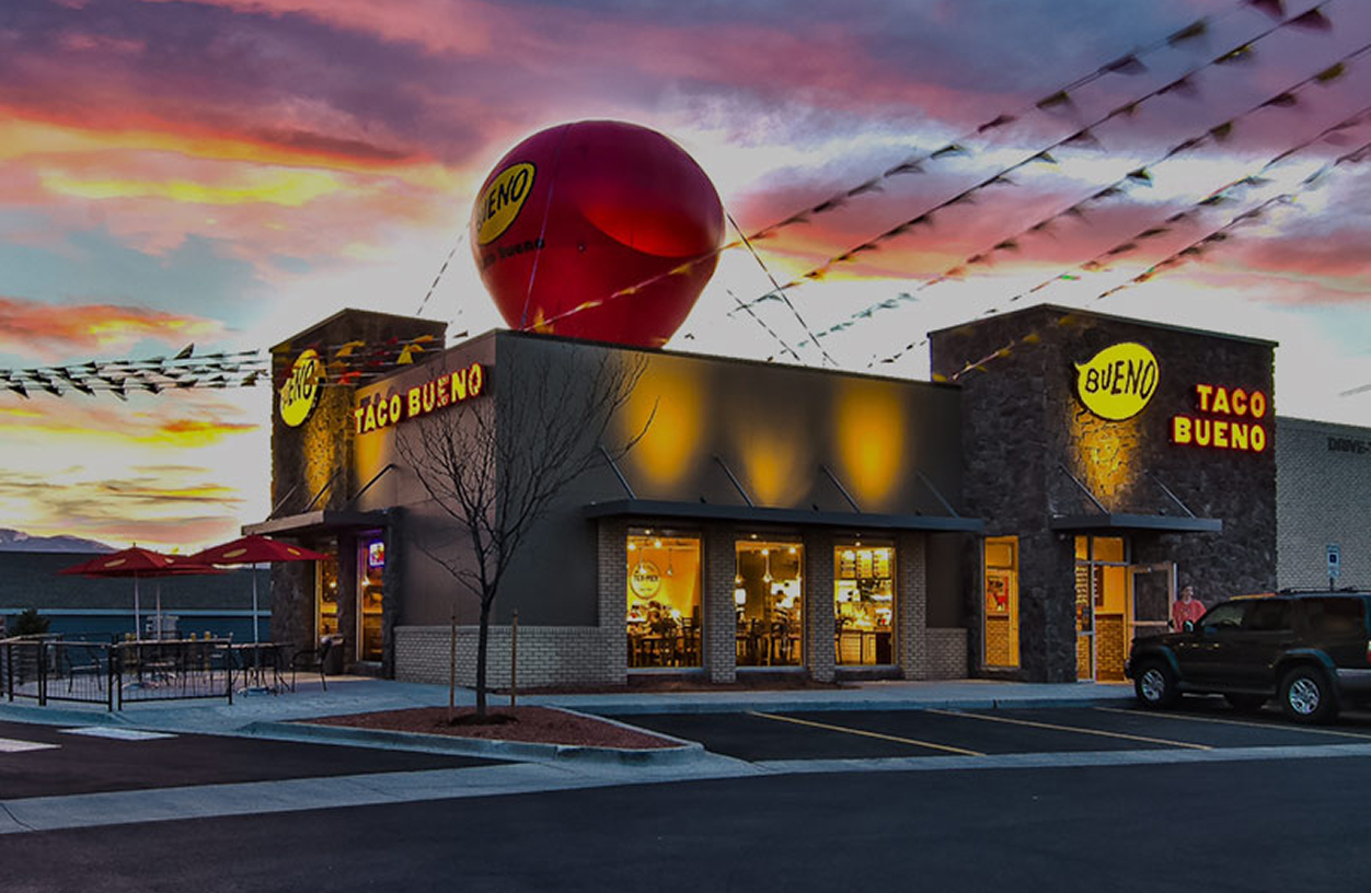 A Taco Bueno restaurant at sunset.